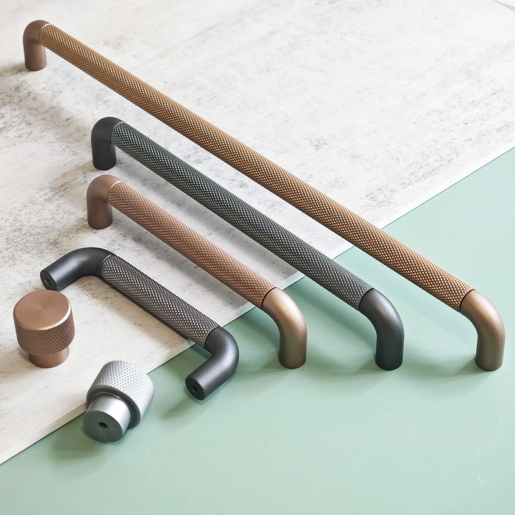 Brass Essence textured zinc alloy bar and knob handle set with modern industrial design, featuring sleek, durable hardware.