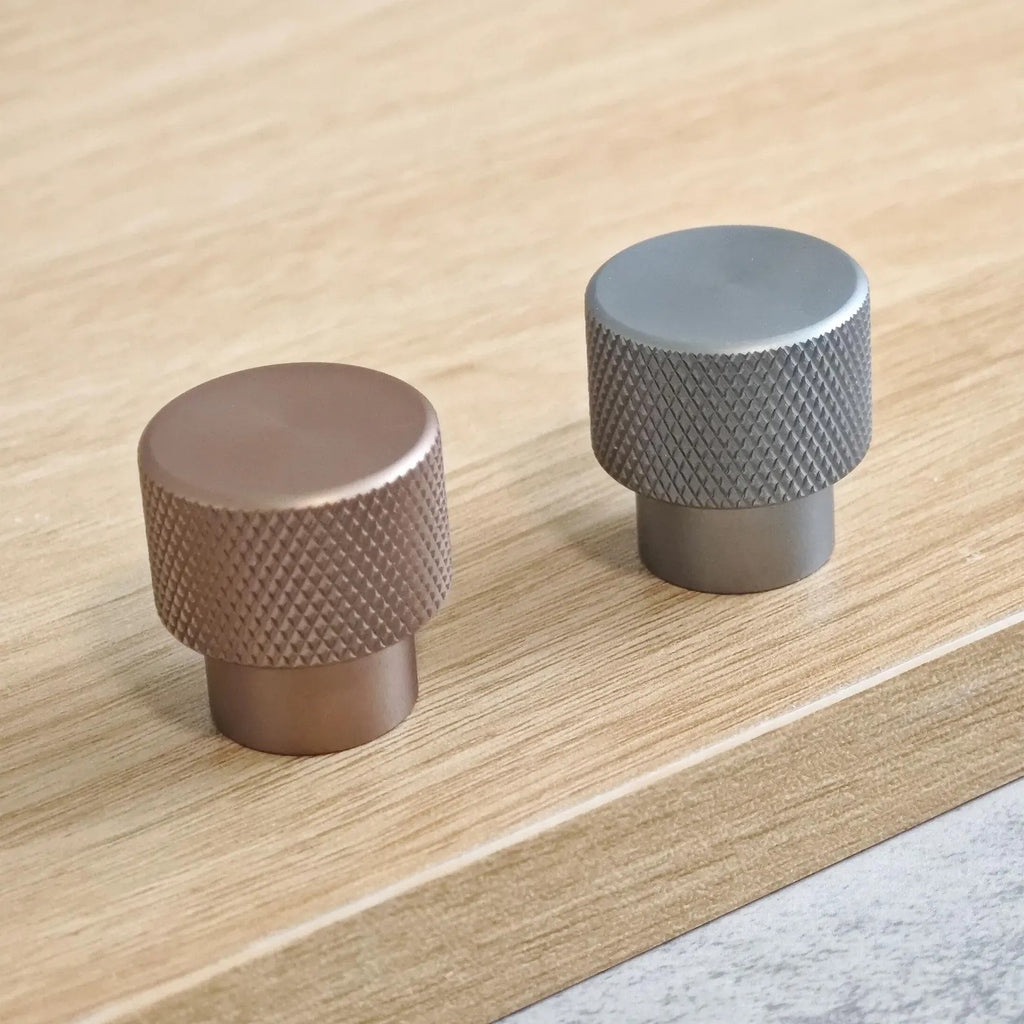 Close-up of Brass essence textured zinc alloy bar and knob handles set with modern industrial design, showing detailed surface finish.