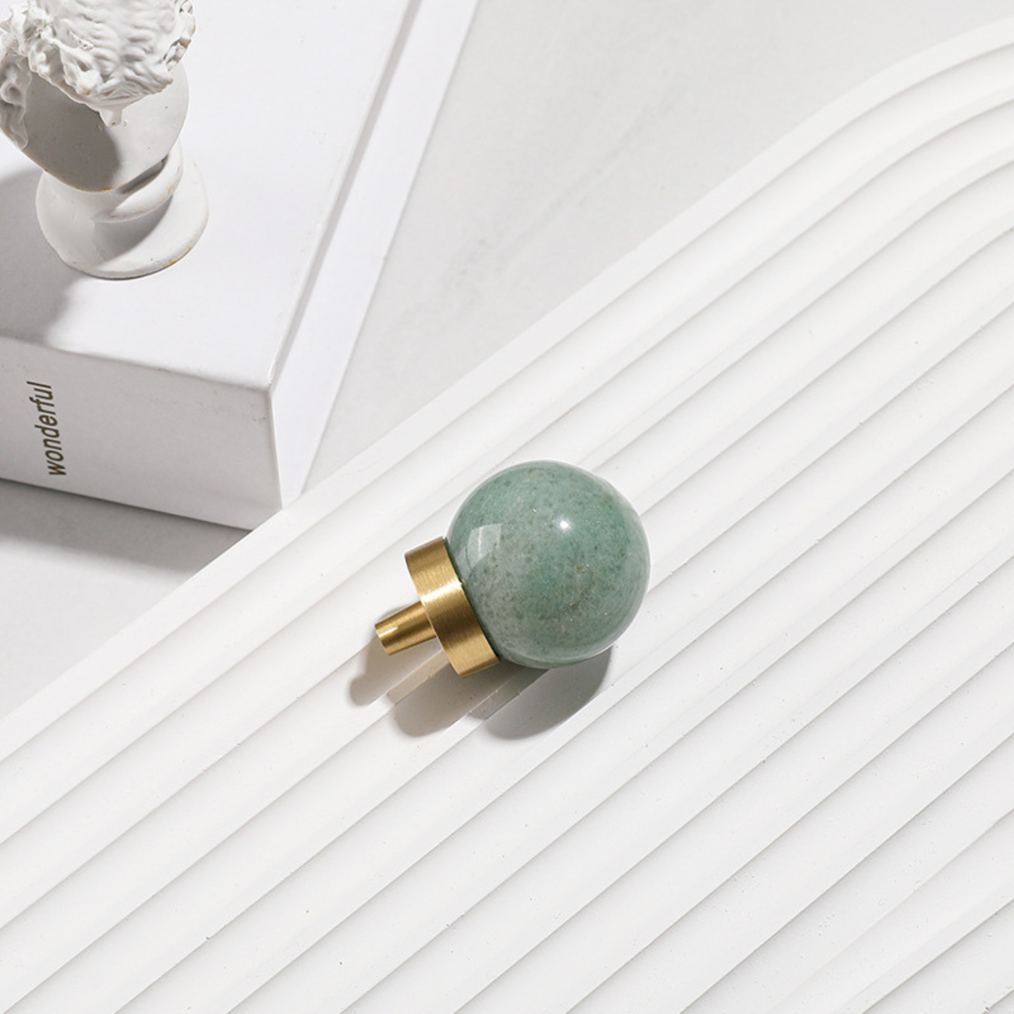 Natural crystal ball and brass cabinet knob by Brass Essence, showcasing a clear crystal sphere with a brass mount.
