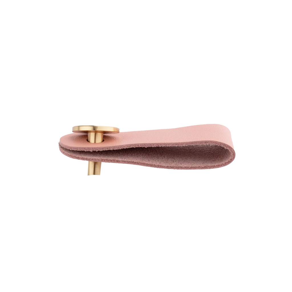 Brass Essence leather and brass strap cabinet pull with sleek design, featuring a leather strap and brass hardware for furniture drawers.