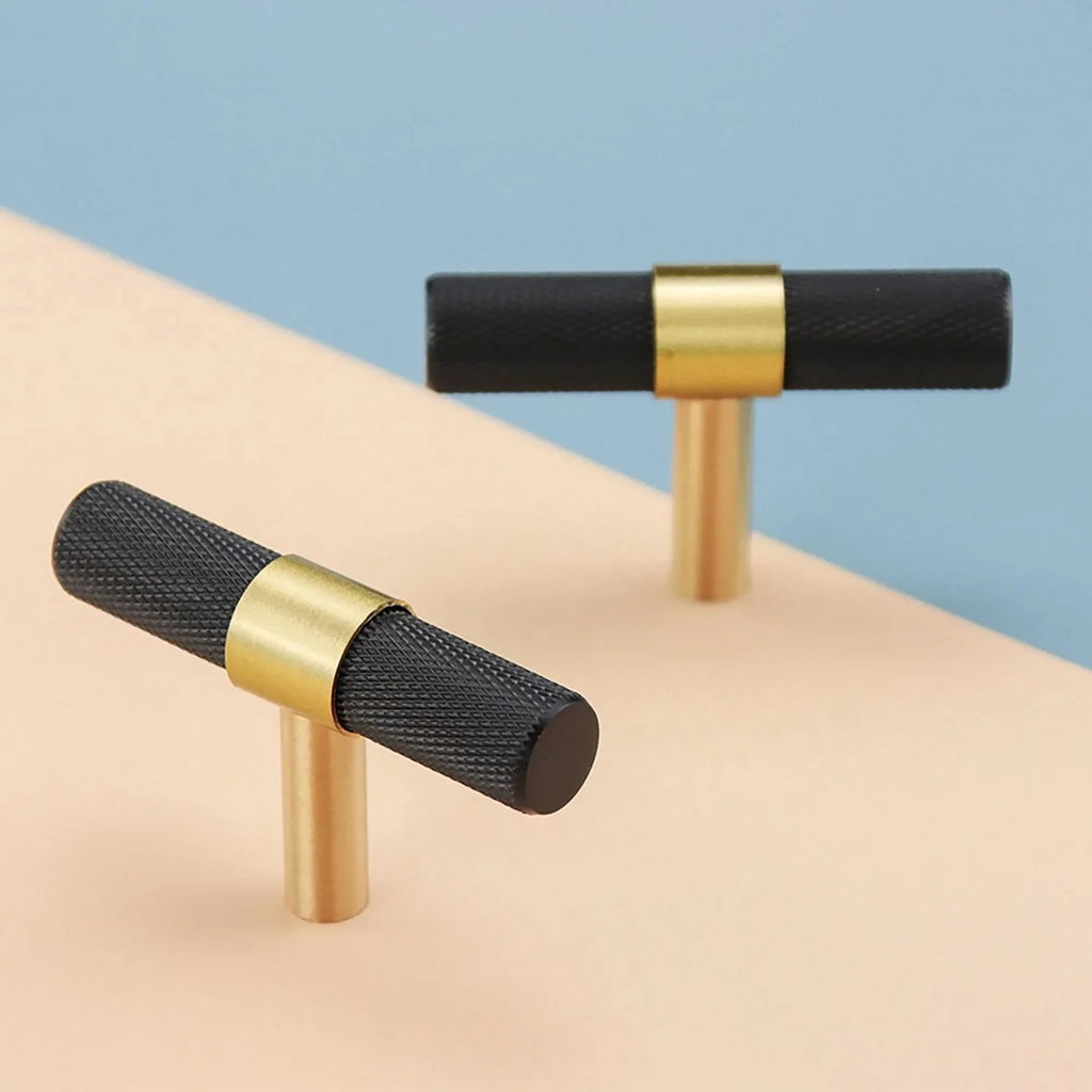 Brass Essence knurled black and gold T-Bar handle from the collection, showcasing textured grip and polished finish.