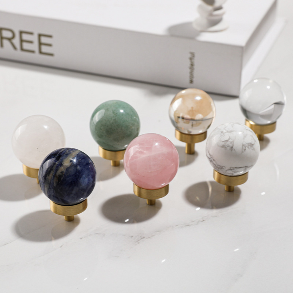 Brass essence natural crystal ball and brass cabinet knob, showcasing the clear crystal sphere and polished brass finish.