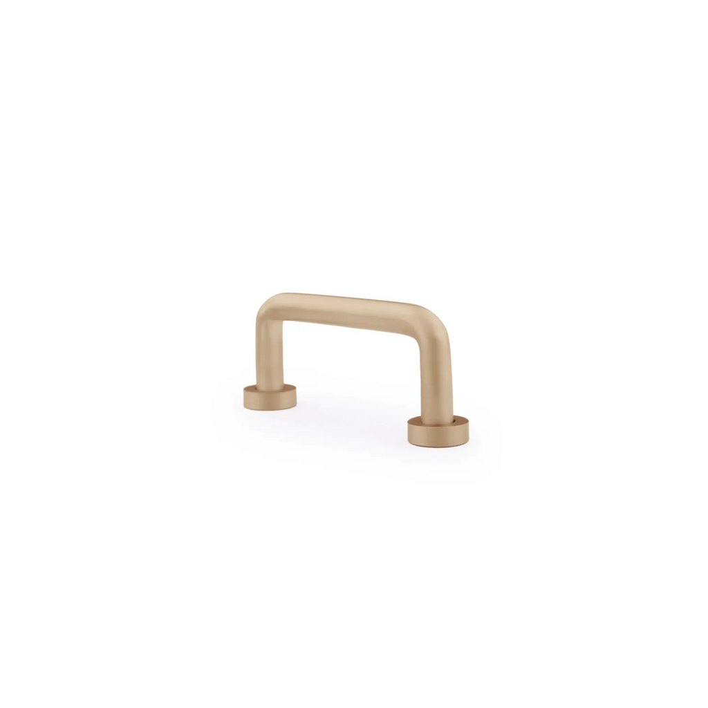 Minimalist solid brass curved handle by Brass essence, showing a sleek, polished brass handle with smooth curves for furniture or cabinetry.