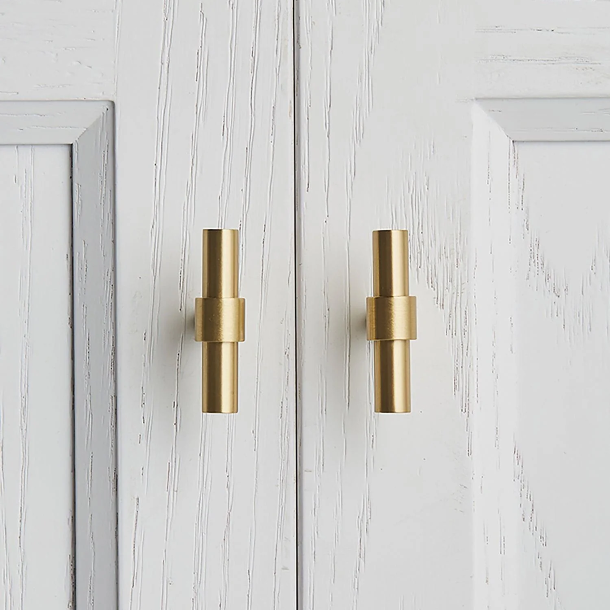 Brass Essence Naveena solid brass T-bar handle from the collection, showing a polished T-shaped handle on a plain background.