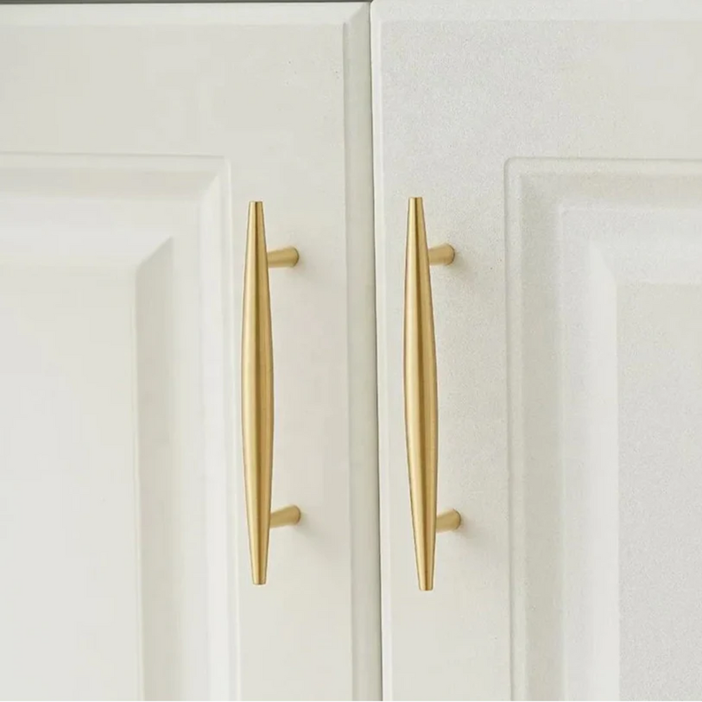 Tapered brass cabinet pull from Brass Essence featuring a smooth, polished finish and ergonomic design for drawer or cabinet use.