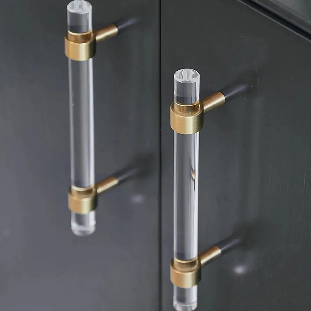 Brass Essence acrylic and brass T-bar handle collection with clear acrylic and polished brass finishes, displayed in a set.