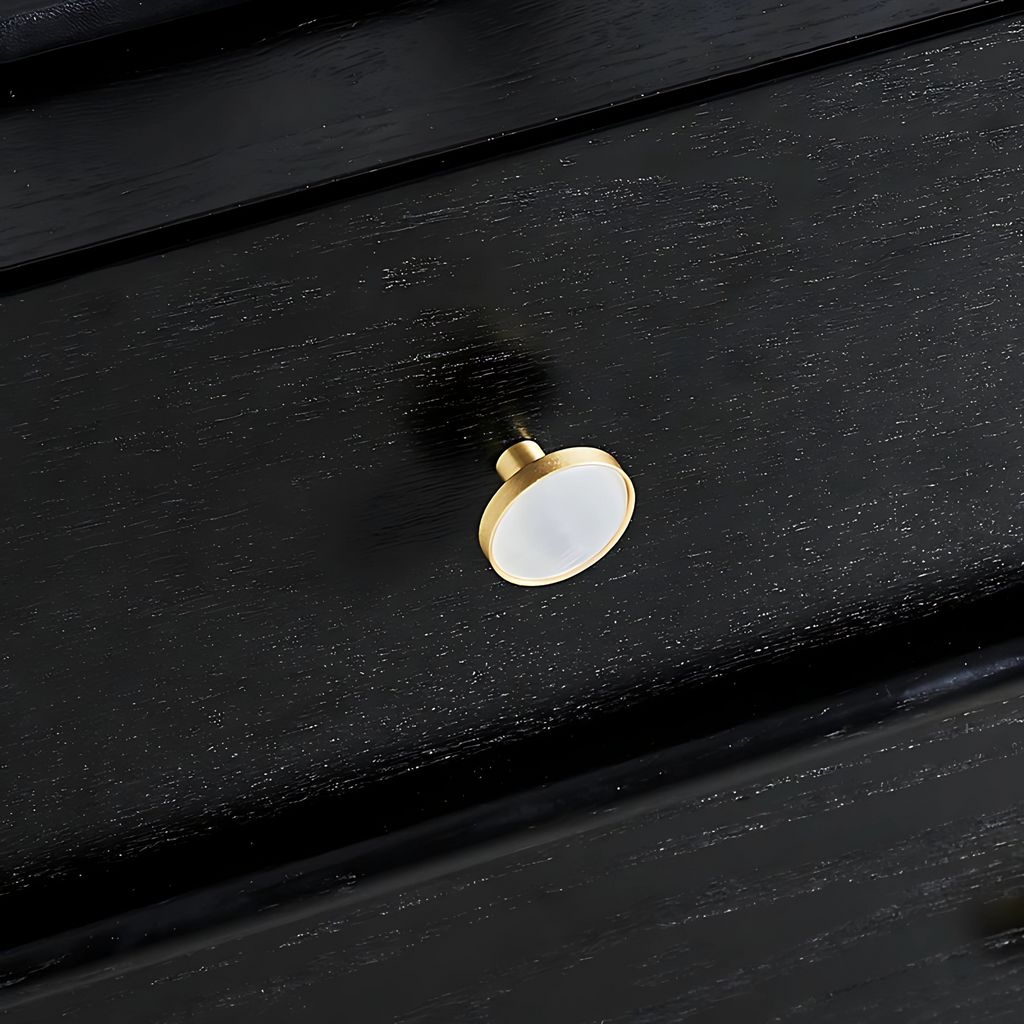 Mother of pearl and brass round cabinet knob by Brass Essence, showing a shiny pearl-inlaid surface with brass accents.