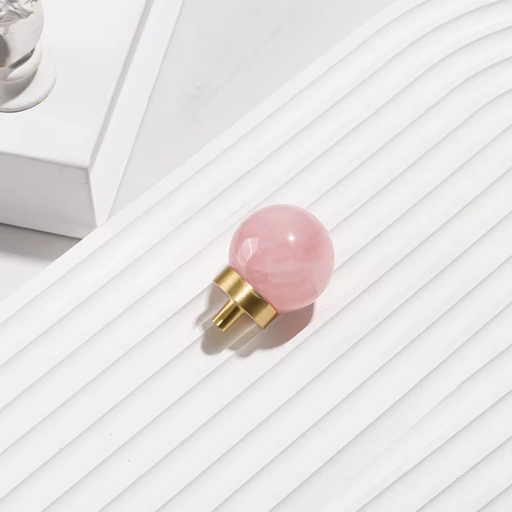 Natural crystal ball and brass cabinet knob by Brass Essence, showcasing a glossy crystal sphere and ornate brass hardware.