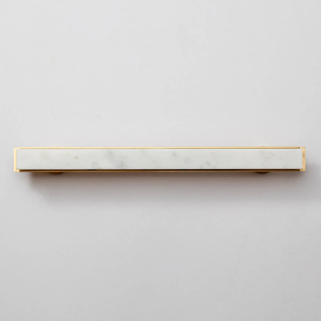 Modern white marble and brass T-bar handle by Brass Essence, showcasing sleek design and polished finish.