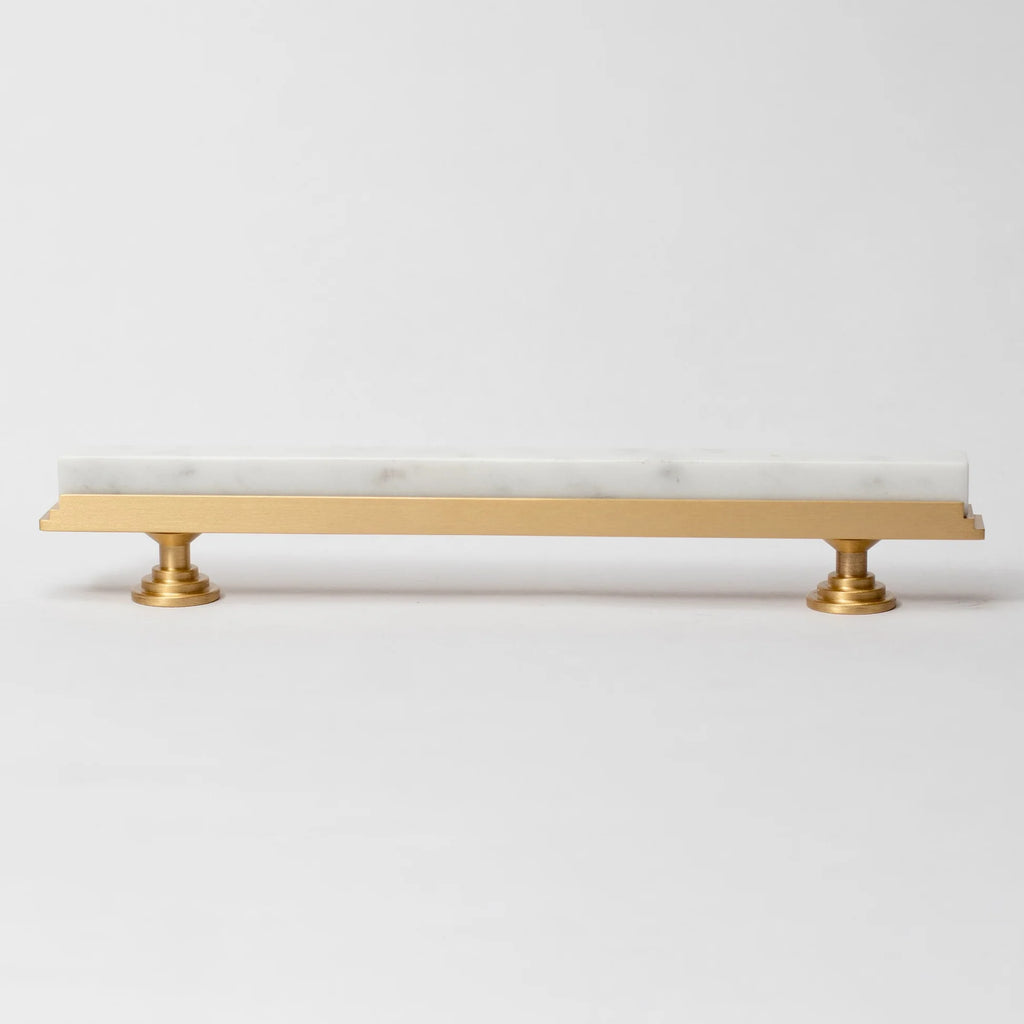 Karish Modern white marble and brass T-bar handle by Brass Essence, showcasing sleek design and polished finish.
