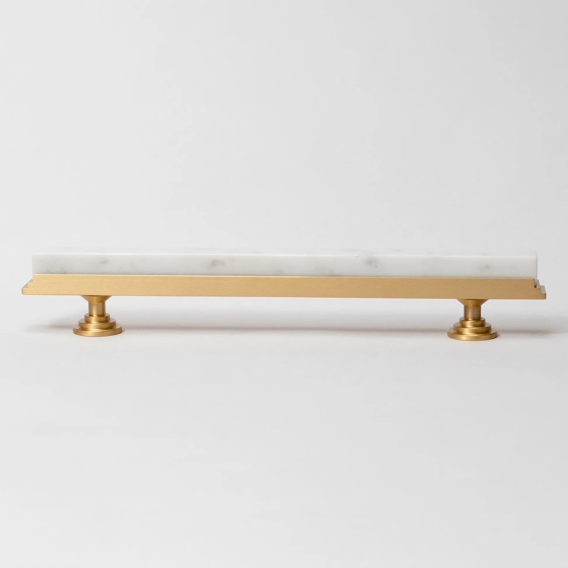 Karish Modern White Marble and Brass T-Bar Handle by Brass Essence, close-up view of elegant bathroom or furniture hardware