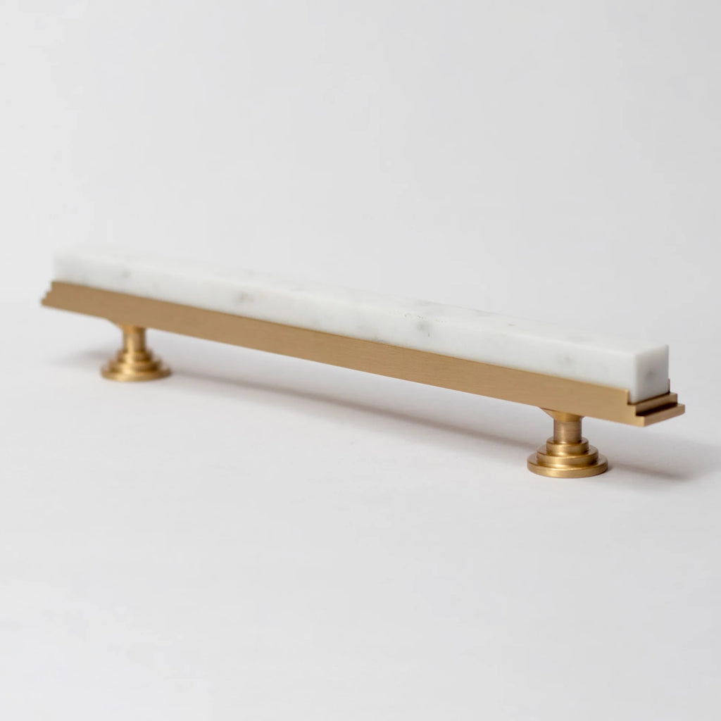 Karish modern white marble and brass T-bar handle by Brass Essence, showcasing sleek design and elegant materials.