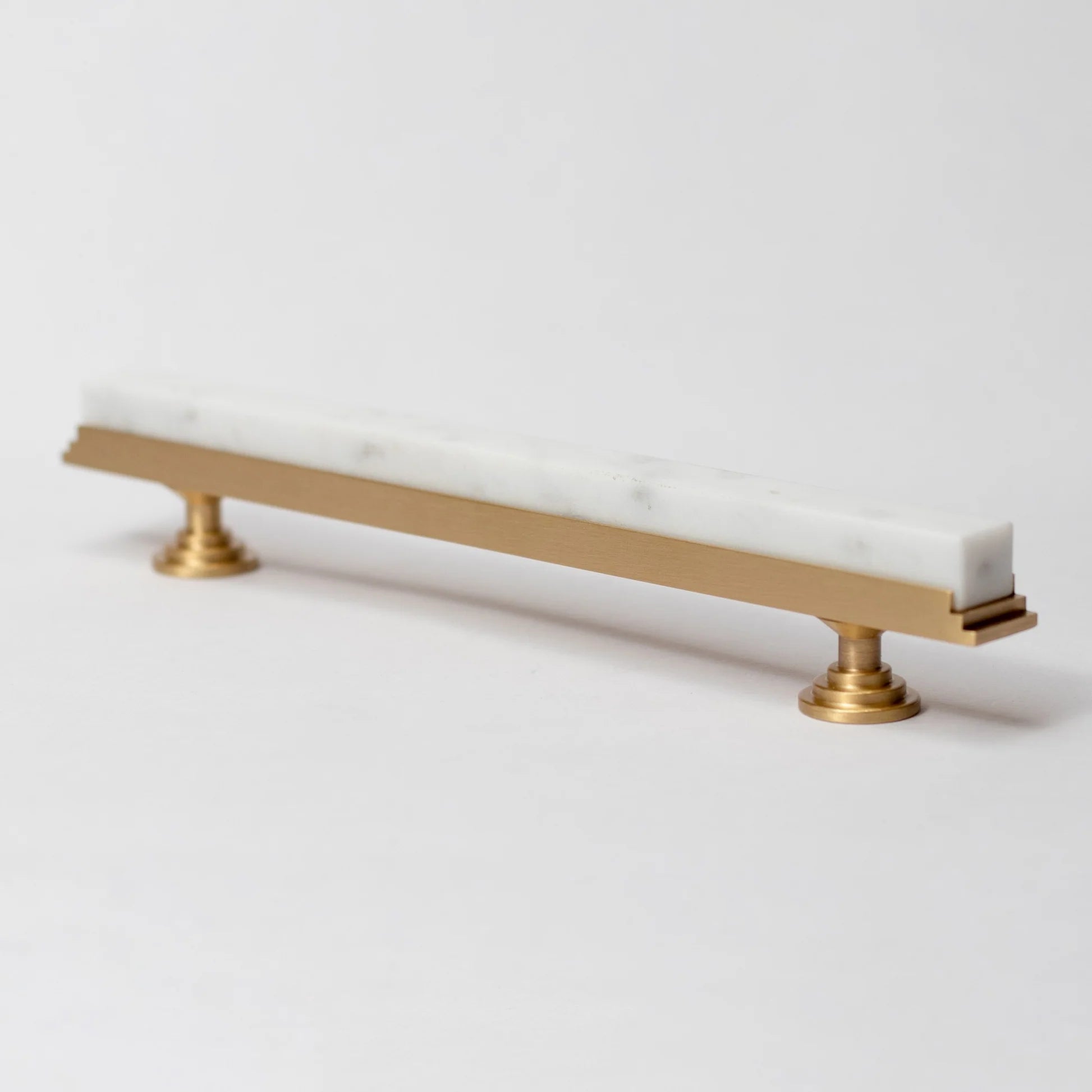 Karish modern white marble and brass T-bar handle by Brass Essence, showcasing sleek design and elegant materials.